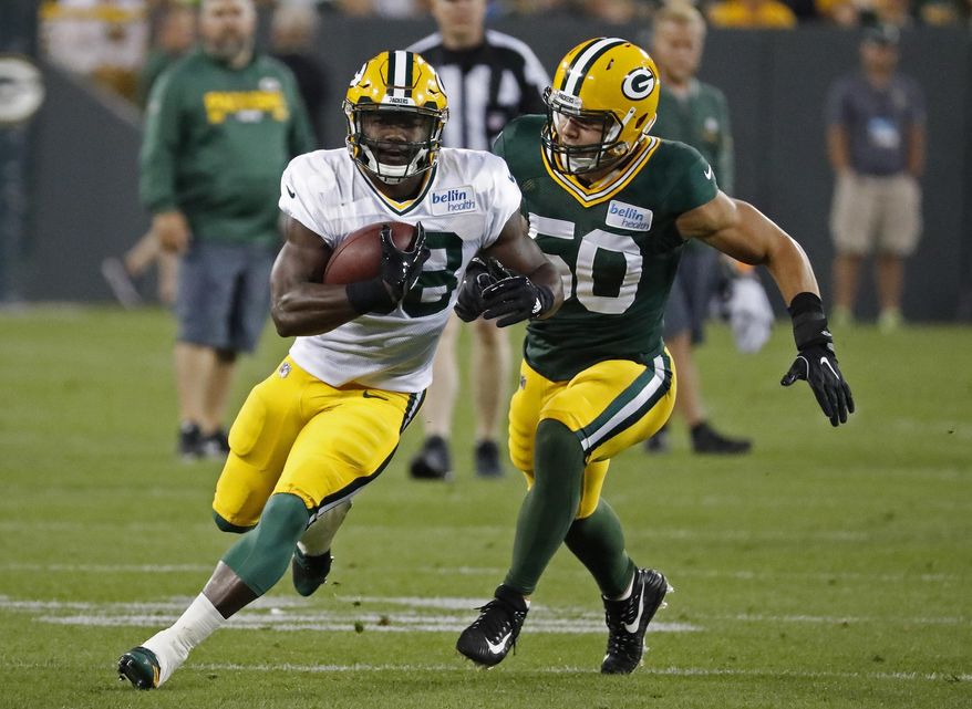 FILE - In this Saturday, Aug. 5, 2017 file photo, Green Bay Packers Ty Montgomery (88) makes a catch while being covered by Blake Martinez (50) during an NFL football training camp practice in Green Bay, Wis. Ty Montgomery is getting much more attention this year in Green Bay Packers camp by virtue of his expanded role on a potent offense. The converted receiver is now the starting running back in a young, but relatively inexperienced backfield. So when Montgomery sits out a practice because of a lower leg injury, like on Tuesday, Aug. 15, 2017, his absence tends to get noticed. (AP Photo/Matt Ludtke, File)