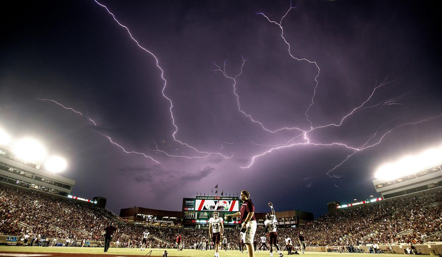 In this Sept. 5, 2015, file photo, a lightning strike occurs as Texas State warms up in Doak Campbell Stadium prior to an NCAA college football game against Florida State in Tallahassee, Fla. Lightning used to kill about 300 Americans a year, but lightning deaths are on pace to hit a record low this year. Scientists say less time spent outside and improved medical treatment have contributed to fewer deaths. (AP Photo/Mark Wallheiser, File)