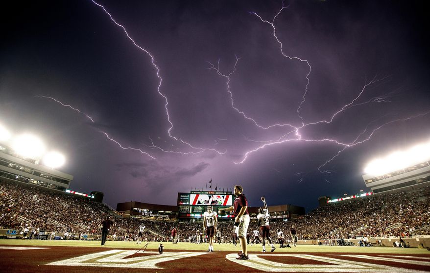 In this Sept. 5, 2015, file photo, a lightning strike occurs as Texas State warms up in Doak Campbell Stadium prior to an NCAA college football game against Florida State in Tallahassee, Fla. Lightning used to kill about 300 Americans a year, but lightning deaths are on pace to hit a record low this year. Scientists say less time spent outside and improved medical treatment have contributed to fewer deaths. (AP Photo/Mark Wallheiser, File)