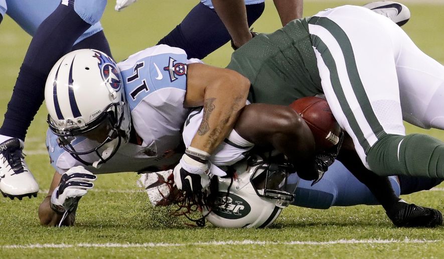 Tennessee Titans wide receiver Eric Weems (14) tackles New York Jets wide receiver Lucky Whitehead (8) during the second quarter of an NFL football game, Saturday, Aug. 12, 2017, in East Rutherford, N.J. (AP Photo/Julio Cortez)