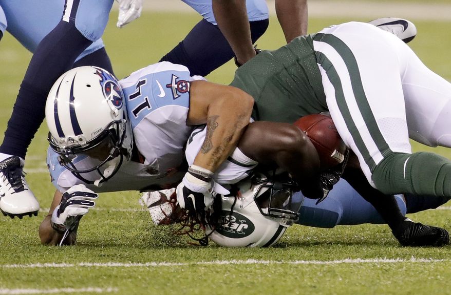 Tennessee Titans wide receiver Eric Weems (14) tackles New York Jets wide receiver Lucky Whitehead (8) during the second quarter of an NFL football game, Saturday, Aug. 12, 2017, in East Rutherford, N.J. (AP Photo/Julio Cortez)