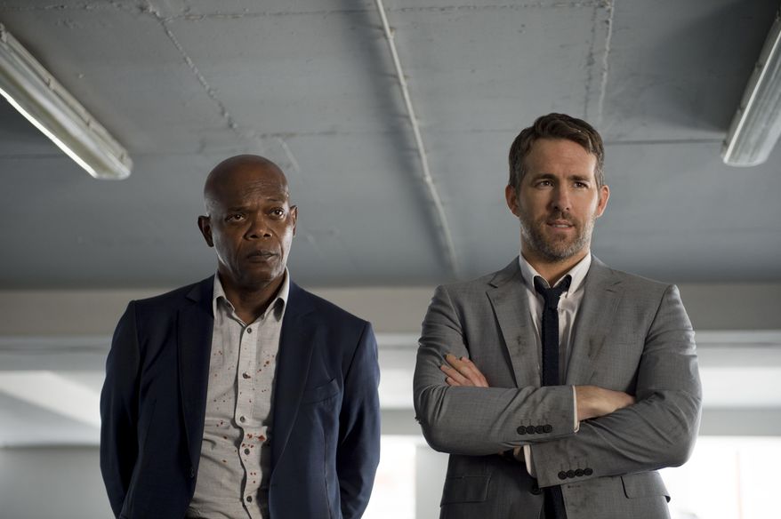 This image released by Lionsgate shows Samuel L. Jackson, left, and Ryan Reynolds in "The Hitman's Bodyguard." (Jack English/Lionsgate via AP)