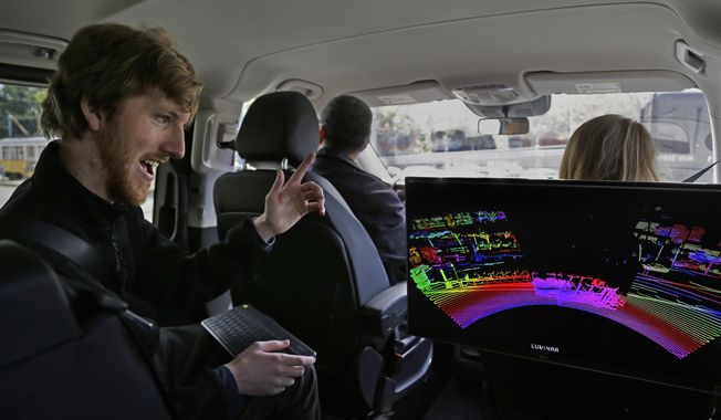 FILE - In this Monday, April 10, 2017 file photo, Luminar CEO Austin Russell monitors a 3D lidar map on a demonstration drive in San Francisco. Russell, now 22, was barely old enough to drive when he set out to create a safer navigation system for robot-controlled cars. His ambitions are about to be tested five years after he co-founded Luminar Technologies, a Silicon Valley startup trying to steer the rapidly expanding self-driving car industry in a new direction. (AP Photo/Ben Margot)