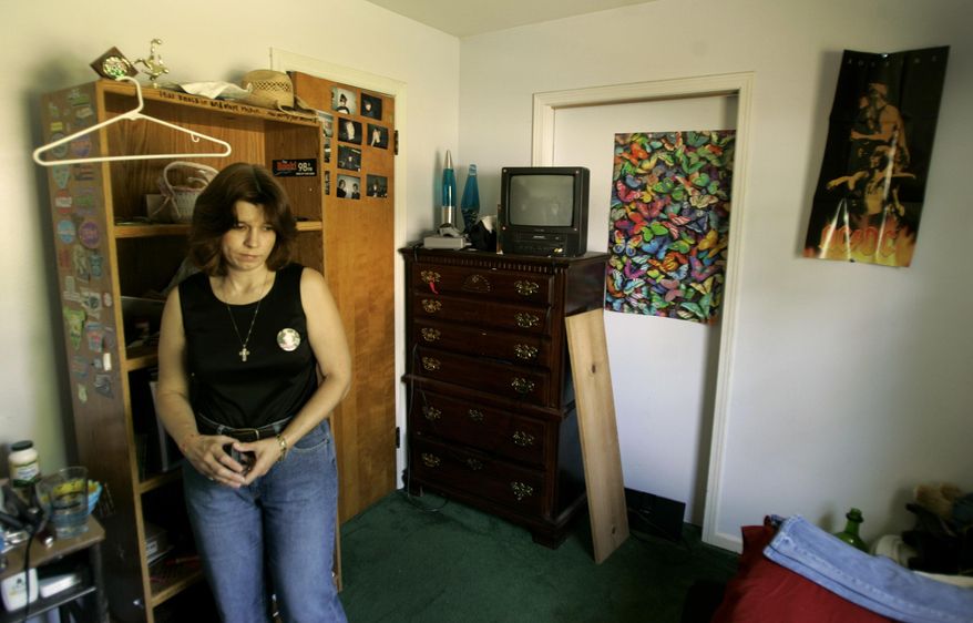 FILE - In this June 8, 2007, file photo, Rhonda Beckford looks around in her daughter, 17-year-old Kara Kopetsky's room during an interview in Belton, Mo. Authorities say human remains found in April 2017 in rural northwest Missouri are those of the 17-year-old girl who was last seen 10 years ago. Belton police Lt. Brad Swanson said in a statement Wednesday, Aug. 16, that the FBI confirmed the remains were those of Kara Kopetsky. (AP Photo/Charlie Riedel, File)