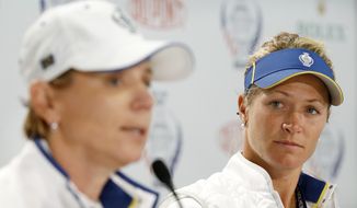 Europe&#x27;s Suzann Pettersen, of Norway, listens as Europe captain Annika Sorenstam, of Sweden, left, speaks during a news conference for the Solheim Cup golf tournament, Wednesday, Aug. 16, 2017, in West Des Moines, Iowa. Pettersen has pulled out of this weekend&#x27;s Solheim Cup because of a back injury. (AP Photo/Charlie Neibergall)