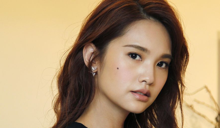 In this photo taken on Saturday, Aug. 5, 2017, Taiwanese actress Rainie Yang poses during an interview with The Associated Press in Taipei, Taiwan. Yang stars in “The Tag Along 2,” a sequel to the 2015 hit that’s loosely based on a ghostly urban legend in Taiwan about a little girl that appears in the footage of a family’s hiking trip. (AP Photo/Chiang Ying-ying)