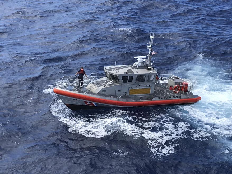 In this photo released by the U.S. Coast Guard, a Response Boat-Medium boat crew from Coast Guard Station Honolulu conducts a search for five crew members aboard a downed Army UH-60 Black Hawk helicopter approximately two miles west of Kaena Point, Oahu, Hawaii, Wednesday, Aug. 16, 2017. A multi-agency team scoured the ocean off Hawaii on Wednesday for the soldiers aboard the Army helicopter that went down during a nighttime training exercise. (Petty Officer 2nd Class Tara Molle/U.S. Coast Guard photo via AP)