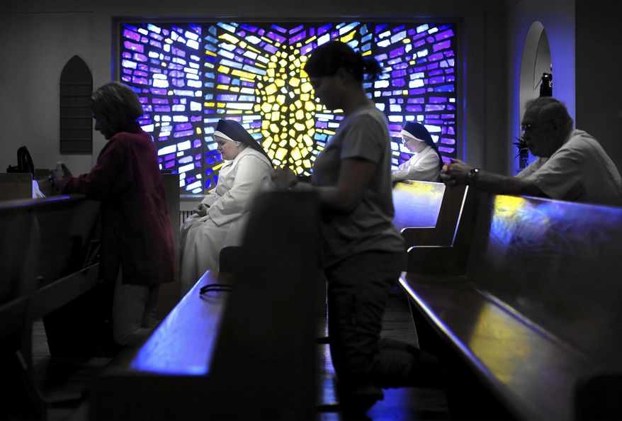 Sisters Faustina, left, and Mother Mary Sarah, right, attend Mass inside the chapel of St. Elizabeth Nursing Home in Janesville, Wis. The nursing home is celebrating its 50th birthday this year. (Anthony Wahl/The Janesville Gazette via AP)