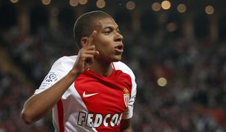 FILE - In this Wednesday, May 17, 2017 file photo, Monaco&#39;s forward Kylian MBappe Lottin celebrates his opening goal during the League One soccer match Monaco against Saint Etienne, at the Louis II stadium in Monaco. Although Kylian Mbappe is considered the rising star of world football, he is again set to be left out of Monaco’s team for Friday Aug. 18, 2017 trip to Metz. (AP Photo/Claude Paris, File)