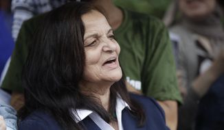 Palestinian activist Rasmea Odeh of Chicago stands outside the Theodore Levin U.S. Courthouse in Detroit, Aug. 17, 2017, for a final court hearing before she&#39;s eventually deported for concealing her convictions in two Jerusalem bombings. Odeh admits that she failed to disclose the convictions when she entered the U.S. and later went through the citizenship process in 2004. She&#39;s not expected to get any time in prison Thursday but has agreed to be deported to Jordan or elsewhere. (AP Photo/Carlos Osorio)