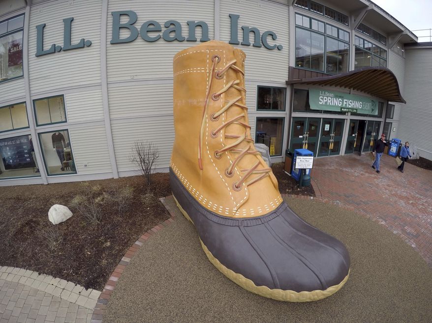 FILE - In this March 16, 2016, file photo, shoppers exit the L.L. Bean retail store in Freeport, Maine. L.L. Bean hopes to give the boot to backlogs of its most iconic product. The Maine-based retailer is expanding production to keep up with demand for its leather-and-rubber “duck boot” with a new manufacturing center that’s being unveiled Thursday, Aug. 17, 2017. The company also plans to hire more than 100 additional production workers at two locations in Maine. (AP Photo/Robert F. Bukaty, File)