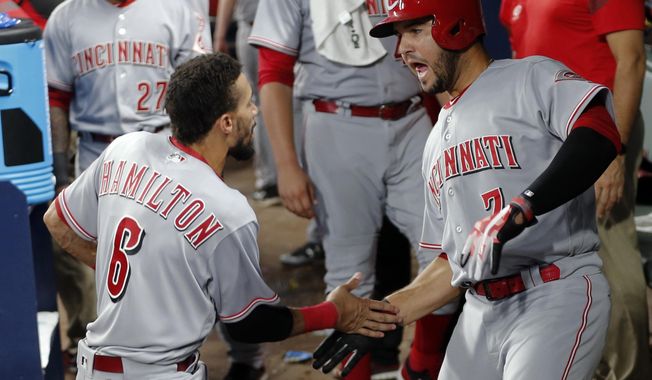 Cincinnati Reds&#x27; Eugenio Suarez (7) celebrates with Billy Hamilton (6) after hitting a home run during the sixth inning of a baseball game against the Atlanta Braves on Friday, Aug. 18, 2017, in Atlanta. (AP Photo/John Bazemore)