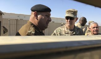FILE - In this Feb. 8, 2-17 file photo, U.S. Army Lt. Gen. Stephen Townsend, center, speaks with an Iraqi officer during a tour north of Baghdad, Iraq. Senior U.S. commanders say Iraqi forces are largely set for their next major campaign against Islamic State extremists. Townsend, the top U.S. commander in Iraq, said he sees the Iraqi assault on the IS-held area of Tal Afar “unfolding relatively soon.” (AP Photo/ Ali Abdul Hassan, File)