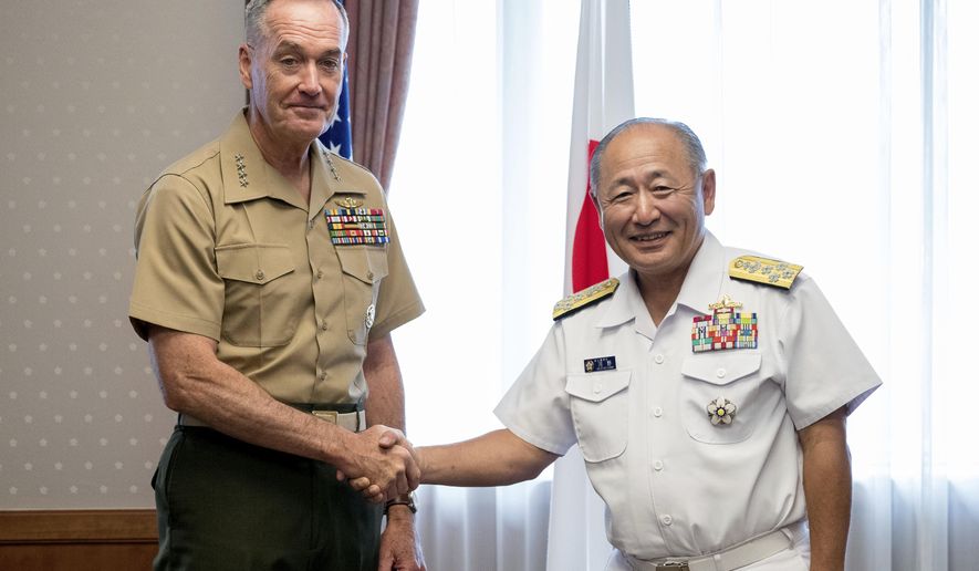 Chairman of the Joint Chiefs of Staff Joseph Dunford, left, poses with Japanese Chief of Staff, Joint Staff Adm. Katsutoshi Kawano for a photo during a meeting at Defense Ministry in Tokyo, Friday, Aug. 18, 2017. (AP Photo/Andrew Harnik)