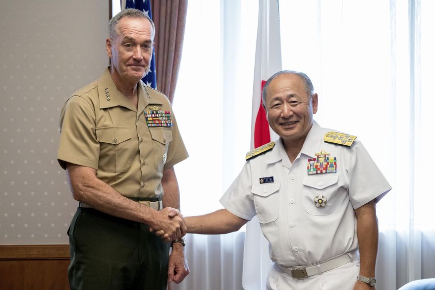 Chairman of the Joint Chiefs of Staff Joseph Dunford, left, poses with Japanese Chief of Staff, Joint Staff Adm. Katsutoshi Kawano for a photo during a meeting at Defense Ministry in Tokyo, Friday, Aug. 18, 2017. (AP Photo/Andrew Harnik)