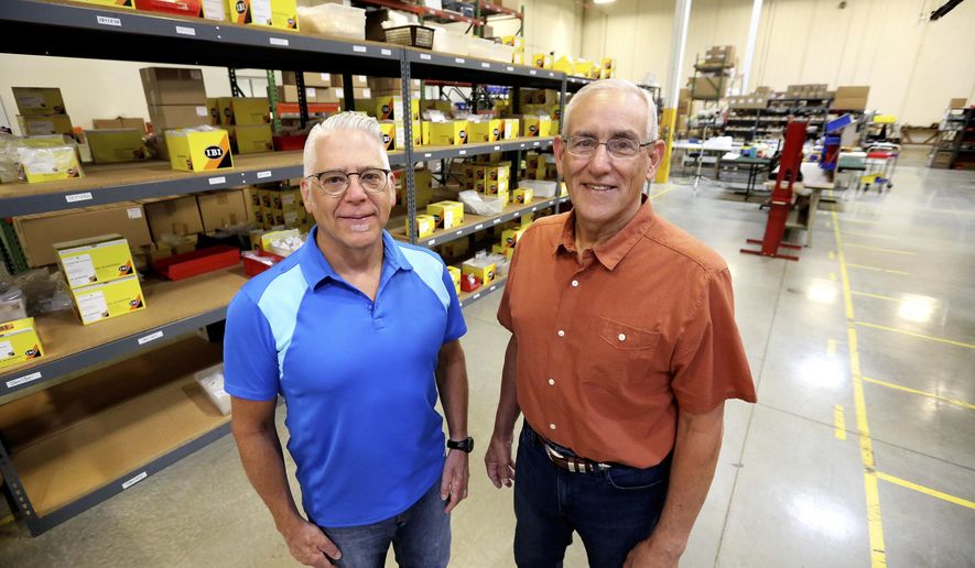 ADVANCE FOR THE WEEKEND OF AUG. 19-20 AND THEREAFTER - In this Wednesday, Aug. 2, 2017, photo, Patrick Mueller, left, and John Stork pose at IBI Scientific in Peosta, Iowa. IBI Scientific manufactures bench-top laboratory equipment, nucleic acid purification products, electrophoresis products, molecular biology reagents, polymerase chain reaction enzymes and more. (Jessica Reilly/Telegraph Herald via AP)