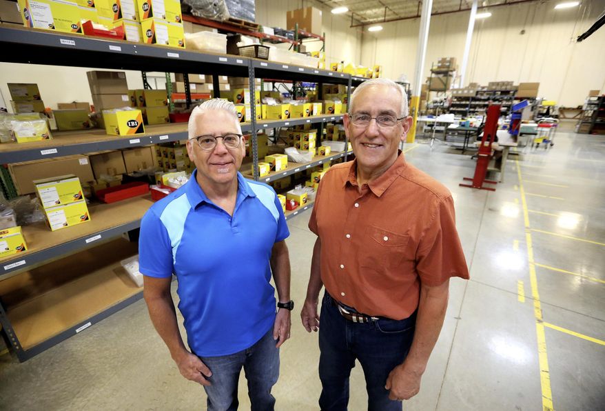 ADVANCE FOR THE WEEKEND OF AUG. 19-20 AND THEREAFTER - In this Wednesday, Aug. 2, 2017, photo, Patrick Mueller, left, and John Stork pose at IBI Scientific in Peosta, Iowa. IBI Scientific manufactures bench-top laboratory equipment, nucleic acid purification products, electrophoresis products, molecular biology reagents, polymerase chain reaction enzymes and more. (Jessica Reilly/Telegraph Herald via AP)