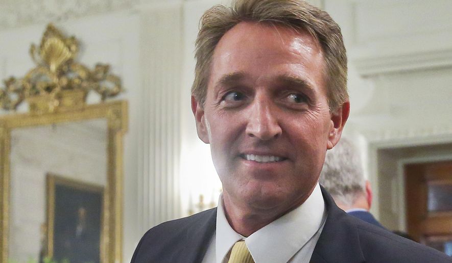 In this July 19, 2017, photo, Sen. Jeff Flake, R-Ariz. walks to his seat as he attends a luncheon with other GOP Senators and President Donald Trump at the White House in Washington. When President Trump takes the stage this week at a rally in Phoenix, Arizona, the state’s junior senator will be nowhere to be seen. But Trump is likely to save some choice words for Sen. Flake (AP Photo/Pablo Martinez Monsivais)
