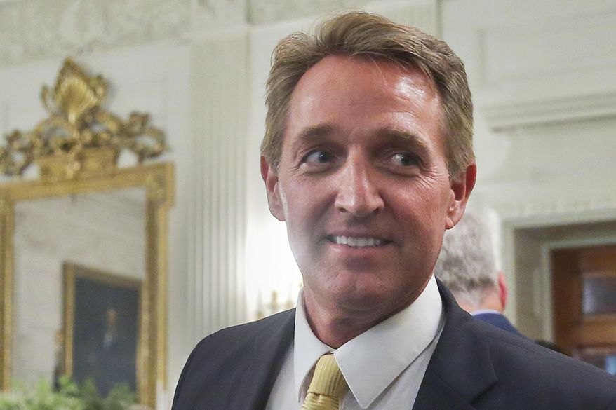 In this July 19, 2017, photo, Sen. Jeff Flake, R-Ariz. walks to his seat as he attends a luncheon with other GOP Senators and President Donald Trump at the White House in Washington. When President Trump takes the stage this week at a rally in Phoenix, Arizona, the state’s junior senator will be nowhere to be seen. But Trump is likely to save some choice words for Sen. Flake (AP Photo/Pablo Martinez Monsivais)