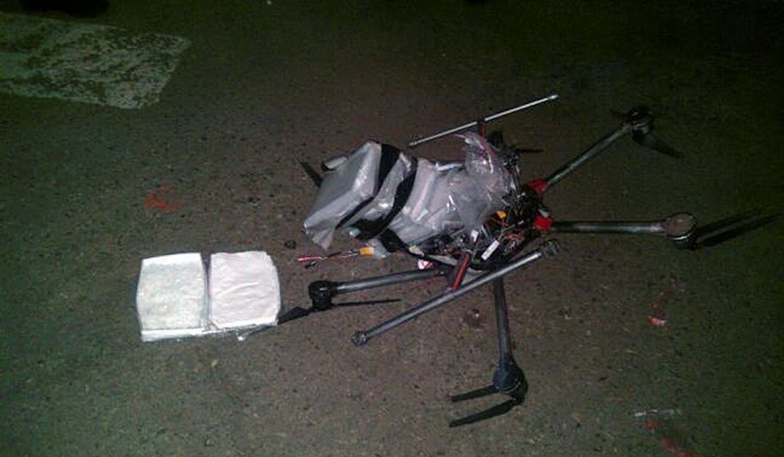 In this image released by the Tijuana Municipal Police on Wednesday, Jan. 21, 2015, a drone loaded with packages containing methamphetamine lies on the ground after it crashed into a supermarket parking lot in the city of Tijuana on Tuesday, Jan. 20, 2015. According to police, six packets of the drug, weighing more than six pounds, were taped to the six-propeller remote-controlled aircraft. (AP Photo/Secretaria de Seguridad P&amp;#250;blica Municipal de Tijuana) ** FILE **