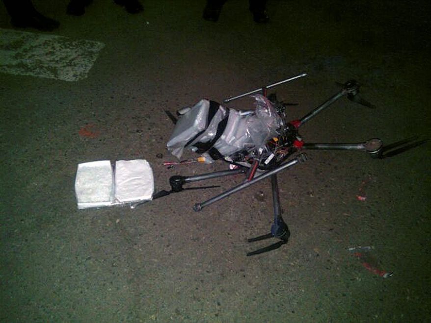 In this image released by the Tijuana Municipal Police on Wednesday, Jan. 21, 2015, a drone loaded with packages containing methamphetamine lies on the ground after it crashed into a supermarket parking lot in the city of Tijuana on Tuesday, Jan. 20, 2015. According to police, six packets of the drug, weighing more than six pounds, were taped to the six-propeller remote-controlled aircraft. (AP Photo/Secretaria de Seguridad P&amp;#250;blica Municipal de Tijuana) ** FILE **