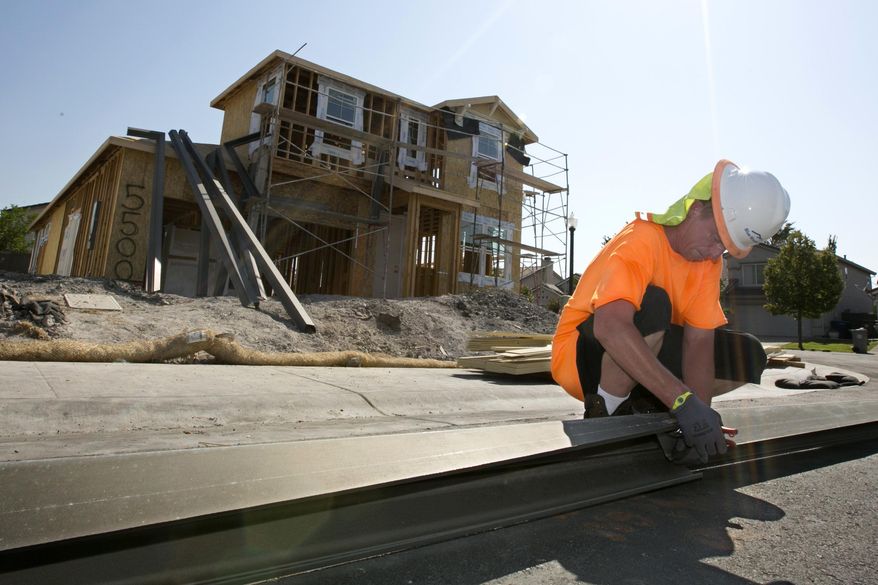 In this photo taken Wednesday, Aug. 16, 2017, sheet metal worker Benjamin Voget prepares to install a gutter on a home under construction in Sacramento, Calif. Gov. Jerry Brown and Democratic legislative leaders promised to tackle California's housing crisis in the final weeks of the legislative session by pushing a package that includes money for low-income housing and regulatory reforms. Lawmakers say the housing shortage is affecting people throughout the state at nearly all income levels. (AP Photo/Rich Pedroncelli)
