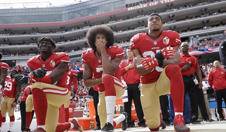 FILE - In this Oct. 2, 2016, file photo, from left, San Francisco 49ers outside linebacker Eli Harold, quarterback Colin Kaepernick, center, and safety Eric Reid kneel during the national anthem before an NFL football game against the Dallas Cowboys in Santa Clara, Calif. What started as a protest against police brutality has mushroomed a year later into a divisive debate over the future of Kaepernick who refused to stand for the national anthem and now faces what his fans see as blackballing for speaking out in a country roiled by racial strife. The once-rising star and Super Bowl quarterback has been unemployed since March, when he opted out of his contract and became a free agent who could sign with any team. (AP Photo/Marcio Jose Sanchez, File)