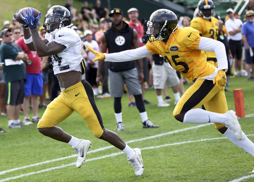 Pittsburgh Steelers wide receiver Antonio Brown (84) gets to a pass past cornerback Artie Burns (25) in a drill at practice during NFL football training camp in Latrobe, Pa., Wednesday, Aug. 16, 2017 . (AP Photo/Keith Srakocic)