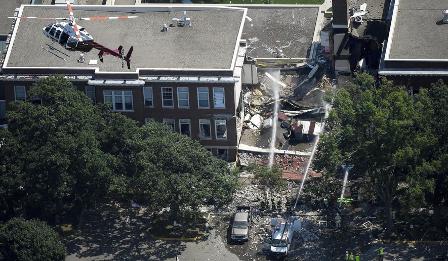 FILE - In this Aug. 2, 2017 file photo, emergency workers respond to an explosion at Minnehaha Academy in Minneapolis. A preliminary report released Monday, Aug. 21, 2017, by the National Transportation Safety Board about the school explosion, says a maintenance worker smelled natural gas and used a radio to tell others to evacuate just a minute before the blast. Two people died when part of a building collapsed. (Aaron Lavinsky/Star Tribune via AP, File)/Star Tribune via AP)