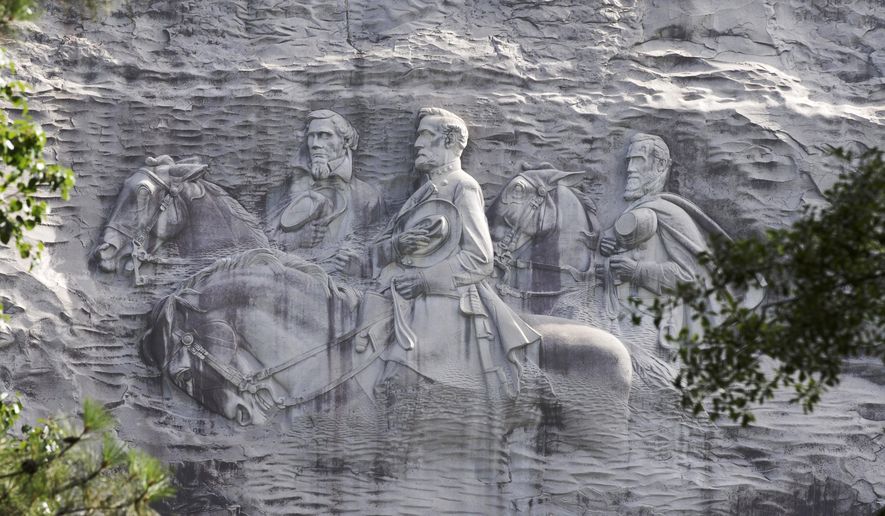 This June 23, 2015, file photo shows the carving depicting Confederate Civil war figures Stonewall Jackson, Robert E. Lee and Jefferson Davis, in Stone Mountain, Ga. (AP Photo/John Bazemore, File)