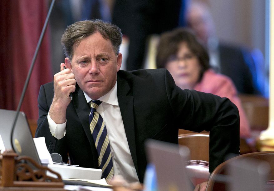 FILE - In this June 15, 2017 file photo state Sen. Josh Newman, D-Fullerton, listens as lawmakers debate a measure to change the rules governing recall elections, at the Capitol, in Sacramento, Calif. California Democrats are again pushing to change recall election rules to help Newman who is facing a recall attempt backed by Republicans over his support for a gas tax increase. (AP Photo/Rich Pedroncelli, File)