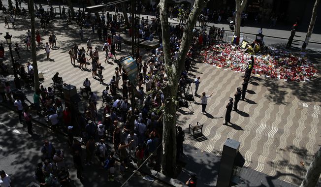 Police officers cordon off the access at Las Ramblas promenade after locating a suspicious backpack in Barcelona, Spain, Monday, Aug. 21, 2017. (AP Photo/Manu Fernandez)