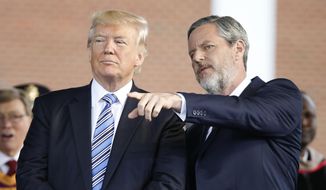 In this file photo taken May 13, 2017, President Donald Trump stands with Liberty University President Jerry Falwell Jr. in Lynchburg, Va. (AP Photo/Steve Helber) ** FILE **