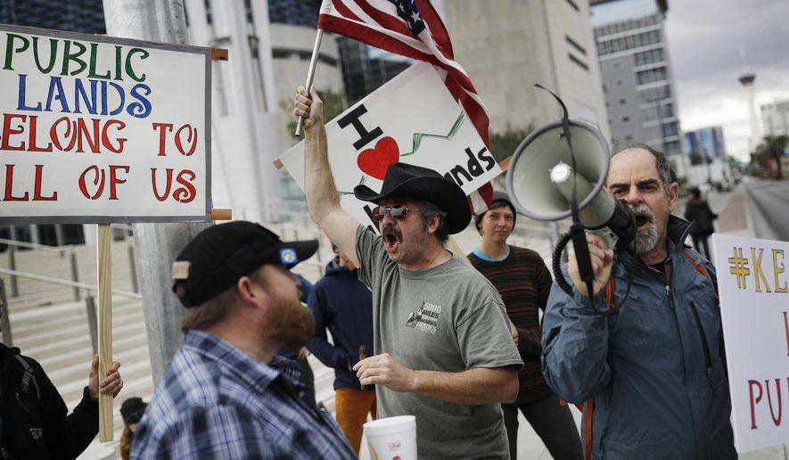 FILE - In this Feb. 6, 2017, file photo, supporters and critics of defendants on trial for charges relating to a 2014 ranch standoff at the federal courthouse gather in Las Vegas. A federal jury in Las Vegas is deliberating again in the retrial of four men accused of wielding assault weapons against federal agents in a 2014 standoff near the Nevada ranch of anti-government figure Cliven Bundy. Jurors returned to work Monday, Aug. 21, 2017, after spending a little more than two days last week going over five weeks of evidence in the case against four defendants. (AP Photo/John Locher, FIle)