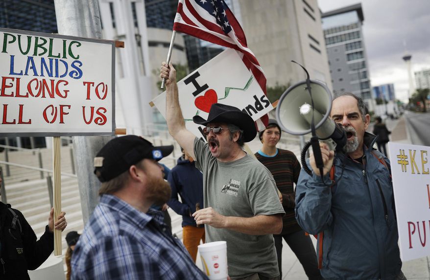 FILE - In this Feb. 6, 2017, file photo, supporters and critics of defendants on trial for charges relating to a 2014 ranch standoff at the federal courthouse gather in Las Vegas. A federal jury in Las Vegas is deliberating again in the retrial of four men accused of wielding assault weapons against federal agents in a 2014 standoff near the Nevada ranch of anti-government figure Cliven Bundy. Jurors returned to work Monday, Aug. 21, 2017, after spending a little more than two days last week going over five weeks of evidence in the case against four defendants. (AP Photo/John Locher, FIle)