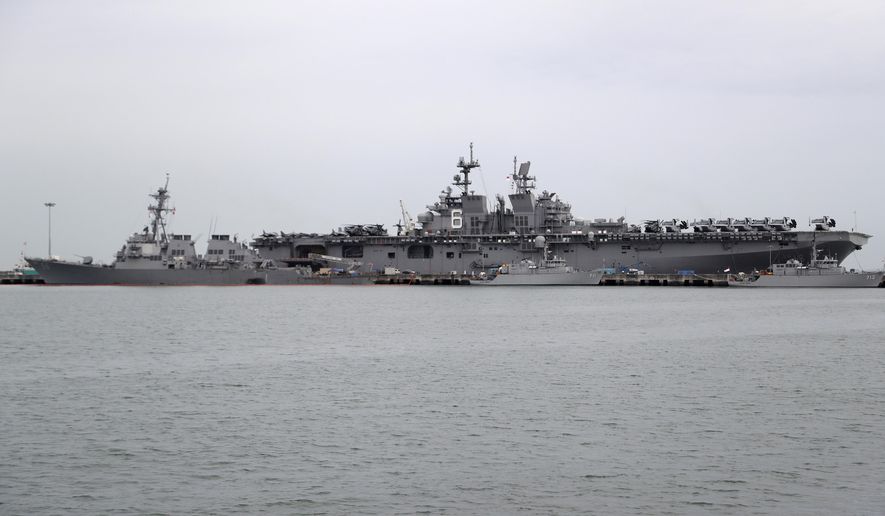 The USS John S. McCain, left, is docked next to USS America at Singapore&#39;s Changi naval base on Tuesday, Aug. 22, 2017, in Singapore. (AP Photo/Wong Maye-E) ** FILE **