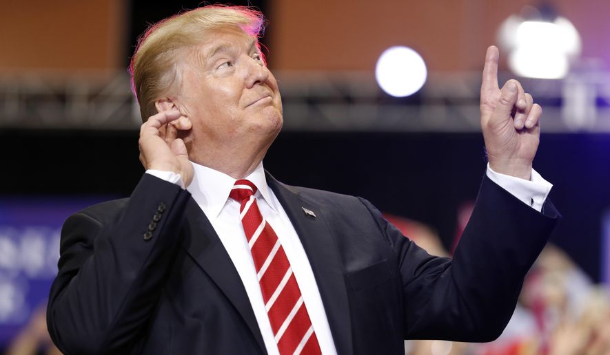 President Donald Trump reacts to the song as he arrives at a rally at the Phoenix Convention Center, Tuesday, Aug. 22, 2017, in Phoenix. (AP Photo/Alex Brandon)