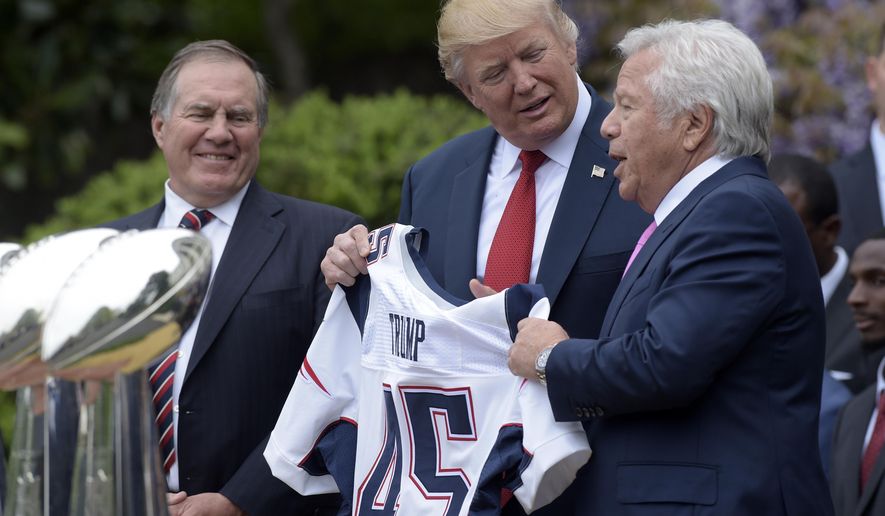 FILE - In this April 19, 2017 file photo, President Donald Trump is presented with a New England Patriots jersey from Patriots owner Robert Kraft, right, and head coach Bill Belichick during a ceremony on the South Lawn of the White House in Washington, where the Patriots were honored for their Super Bowl LI victory. In addition to the jersey, the team confirmed on Tuesday, Aug. 22, 2017, that Kraft decided after the team&#x27;s visit to also have a Super Bowl championship ring made for Trump. (AP Photo/Susan Walsh, File)