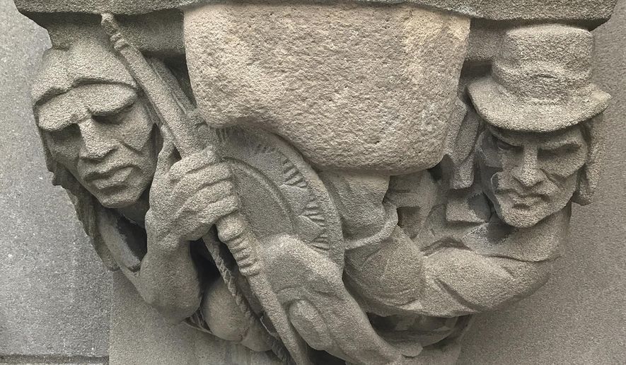 In this July 20, 2017, file photo provided by Yale University, a 1929 doorway carving on the school's New Haven, Conn., campus depicts a Puritan settler, right, with a musket pointing at the head of a Native American, left, which had been covered by workers with removable stone when the seldom-used doorway was converted into a main entrance. A Yale committee charged with assessing potentially offensive art decided to remove it, but will make it available for public display elsewhere so as to not destroy "reminders of unpleasant history." (Yale University via AP) ** FILE **