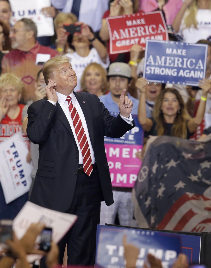 President Donald Trump gestures to the crowd while speaking at a rally at the Phoenix Convention Center, Tuesday, Aug. 22, 2017, in Phoenix. (AP Photo/Rick Scuteri)