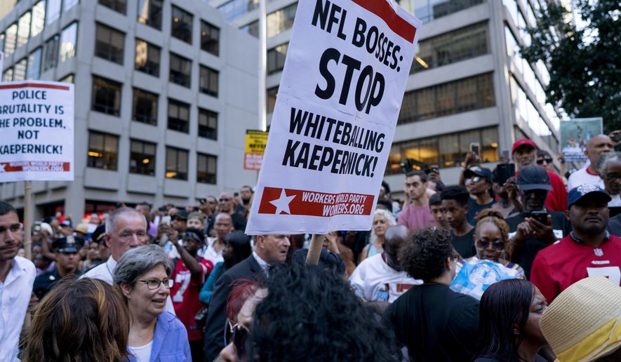 People gather in support of unsigned NFL quarterback Colin Kaepernick on Wednesday, Aug. 23, 2017, outside NFL headquarters in New York. (AP Photo/Craig Ruttle)