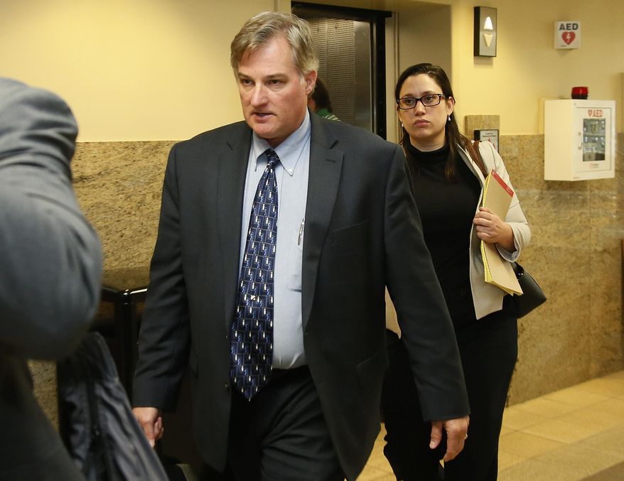FILE - in this Friday, June 30, 2017, file photo, Shannon Kepler, left, arrives with his legal team for afternoon testimony in his third trial in Tulsa, Okla. Kepler, a former Tulsa, Okla., police officer facing a fourth trial in the killing of his daughter's black boyfriend has been referred to as white since the 2014 shooting. Now, he is claiming membership in an American Indian tribe, and says it's up to federal prosecutors to try him. (AP Photo/Sue Ogrocki, File)