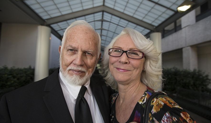 FILE - In this undated file photo, Dan and Fran Keller pose outside of the Travis County courthouse in Austin, Texas. The Texas couple will receive $3.4 million from the state for being wrongfully imprisoned for more than two decades on prosecutors' claims that they sexually abused children as part of satanic rituals at the day care they operated. The Austin American-Statesman reports that Dan and Fran Keller learned Tuesday, Aug. 22, 2017, that they'll receive the payment from a state fund for the wrongly convicted. (Ricardo B. Brazziell/Austin American-Statesman via AP, File)