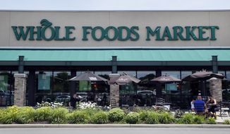 This Friday, June 16, 2017, file photo shows a Whole Foods Market in Indianapolis. Amazon is moving swiftly to make big changes at Whole Foods, saying it plans to cut prices on bananas, eggs, salmon, beef and more as soon as it completes its $13.7 billion takeover. (AP Photo/Michael Conroy, File)