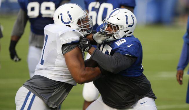 File-This Aug. 1, 2017, file photo shows Indianapolis Colts offensive guard Denzelle Good, left, blocking defensive tackle Johnathan Hankins (95) during practice at the NFL team&#x27;s football training camp in Indianapolis. (AP Photo/Michael Conroy, File)