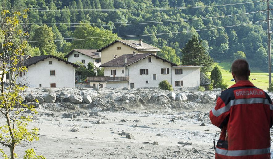 In this photo taken Wednesday, Aug. 23, 2017 shows a landslide that hit the village Bondo in southern Switzerland. Police say, Thursday, Aug. 24, 2017 eight people remain missing a day after mud- and rockslides swept through the small Swiss village near the Italian border. (Giancarlo Cattaneo/Keystone via AP)
