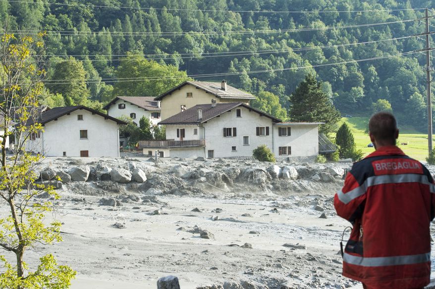 In this photo taken Wednesday, Aug. 23, 2017 shows a landslide that hit the village Bondo in southern Switzerland. Police say, Thursday, Aug. 24, 2017 eight people remain missing a day after mud- and rockslides swept through the small Swiss village near the Italian border. (Giancarlo Cattaneo/Keystone via AP)