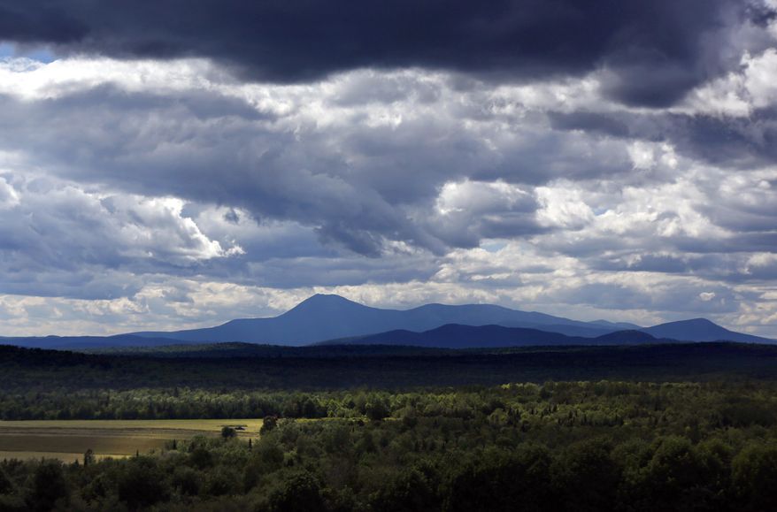 In this Wednesday, Aug. 9, 2017, photo, unsettled clouds fill the sky over Mount Katahdin in this view from Patten, Maine. (AP Photo/Robert F. Bukaty) **FILE**
