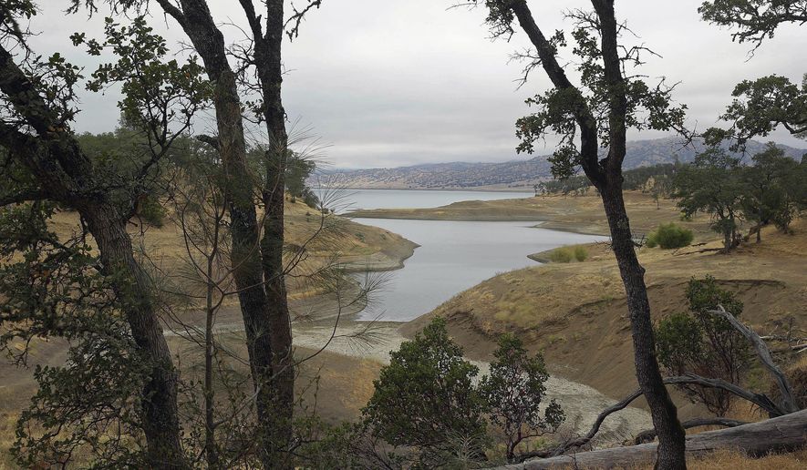 FILE - In this July 10, 2015, file photo, trees frame Lake Berryessa with California&#39;s newest national monument in the background near Berryessa Snow Mountain National Monument, in Calif. Interior Secretary Ryan Zinke said he’s recommending that none of 27 national monuments carved from wilderness and ocean and under review by the Trump administration be eliminated. (AP Photo/Eric Risberg, File)