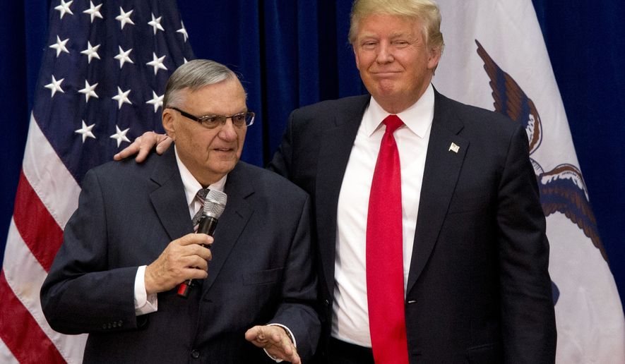 In this Jan. 26, 2016 file photo, then-Republican presidential candidate Donald Trump is joined by Joe Arpaio, the sheriff of metro Phoenix, at a campaign event in Marshalltown, Iowa. (AP Photo/Mary Altaffer, File)